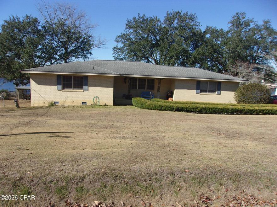 This property offers a wonderful opportunity in a peaceful, scenic part of the Florida Panhandle near Bonifay, with some truly appealing features that stand out.  The spacious layout is a real highlight—three bedrooms plus 2.5 baths, along with a formal living room, formal dining room, den, game room, and two bonus rooms—providing plenty of flexible space for family living, entertaining, hobbies, or even a home office setup. It's generous square footage that feels like a true family home with room to spread out. The water view of Dogwood Lake is a standout perk, complete with a dock (ready for some TLC to make it perfect again) and a screened-in porch overlooking the water. That kind of serene lakefront outlook brings a relaxing, resort-like vibe right to your backyard—great for morning coffee, evening sunsets, or just enjoying the calm. Golf enthusiasts will love the unbeatable convenience: Dogwood Lakes Golf Course is literally across the road, with the clubhouse just a short walk away. It's an affordable, well-regarded 18-hole course known for its rolling fairways, tree-lined play, and friendly atmosphere—perfect for casual rounds or becoming a regular spot. For outdoor fun, you're only about five minutes from Wrights creek a local hidden gem swimming hole that's popular for cooling off in the Panhandle's natural waters. And when you're ready for the beach, Panama City Beach is roughly an hour away—easy access to white sands, Gulf waters, and all the coastal attractions without being right in the busy tourist zone every day. The roof being only 7 years old is a solid plus for peace of mind, and while the home is dated and ready for updates, that's exactly what makes it such a great canvas—buyers can put their personal stamp on it while enjoying all these desirable location benefits and generous living spaces right away. It's a charming spot with lake life, golf, nature, and beach proximity all wrapped up in one package!
