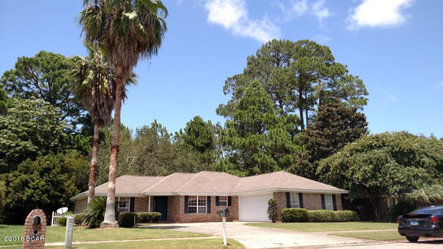All brick 3 bedroom, 2 bath home close to Tyndall AFB. This well-maintained home with split bedroom floorplan boasts a master suite with walk in closet and ensuite bathroom with jetted tub. Great for entertaining, the updated kitchen is open to the dining area and has an island with breakfast bar. Large living area has wood floors and french doors that open to a large Florida room that can be cooled with separate air. Home also features side-entry two-car garage and a fenced back yard. Front loading washer and dryer are included. Dogs are allowed with approval and non-refundable pet fee.