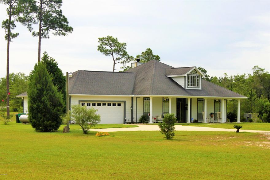 Welcome to your private retreat located on over 20 acres of cleared and partially cleared land featuring two beautiful ponds.  As you pull through the private drive you will follow a winding road through the trees to a 3 bed/2 bath home with an additional office or small bedroom.  The property and exterior features hardi board siding, large insulated windows, 2 car garage w/cabinetry, whole house generator, irrigation system, 2 tank septic w/ lift, 2 wells and 2 ponds on site.  The home has a 2014 AC and insulation on interior and exterior walls for energy economy to include the garage.  The interior features include a split bed floor plan, recessed lighting, huge stone fireplace, Oak floors in Master Bed, Office and Entry, tile throughout the social areas and a security system for safety. The gourmet kitchen is spectacular due to its beautiful granite counter tops, stainless appliances and Craftmade wooden cabinets.  There is a large utility room next to the kitchen to make laundry easy.  The Master Bedroom is truly amazing with its french doors leading to the rear screened patio, ceiling architecture, wood floors and en suite bath.  The Master Bath has many wonderful amenities like 2 large walk in closets, hidden water jacket, Jacuzzi tub with TV, separate vanities and walk in shower with glass door and seat.  This property also has 50 amp service on the outside of home with water for that visitor in an RV.  Don't miss this opportunity so call today and visit this home before you miss it.  Look for video using the address on your favorite streaming site.