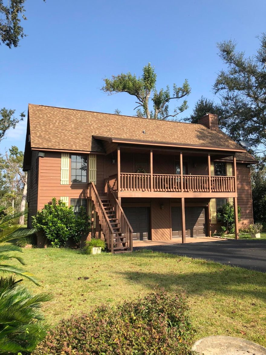 CURRENTLY UNDER CONTRACT, SELLER ACCEPTING BACK UP OFFERS Beautifully maintained riverfront home! Come enjoy breath taking views of the Chipola River off your private deck. Two access points to the river allow for fishing and a dock to tie your boat to. Inside you'll find an open concept main area, boasting a large stone fireplace in the living room. Master and an additional bedroom finish off downstairs, while a loft bedroom with half bath are upstairs. Master bath has access to the spacious back deck overlooking the river. Well lit garage with enough space for a boat/ATV/lawn mower and all your toys! Includes two built in workbenches and additional cabinet storage. Approx measurements for garage are 50x30.  This home is equipped with an outdoor kitchen and an elevator!