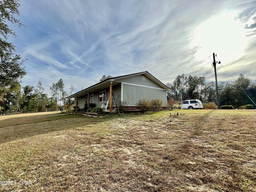 CURRENTLY UNDER CONTRACT, SELLER ACCEPTING BACKUP OFFERS.  Adorable remodeled 3/2, completely chain-link fenced and gated, with a Lake Seminole view. This home comes with an additional 1200 sq ft garage/outbuilding that has 576 sq ft that is enclosed and ready for many different options! Attached to the home you'll have a carport with a covered breezeway to the back entrance, into the kitchen and dining area. Home has new metal roof, new siding, and new flooring. With all the farmhouse style, you'll feel right at home as soon as you step in the door. Make an appointment to take a look, you'll like what you see!