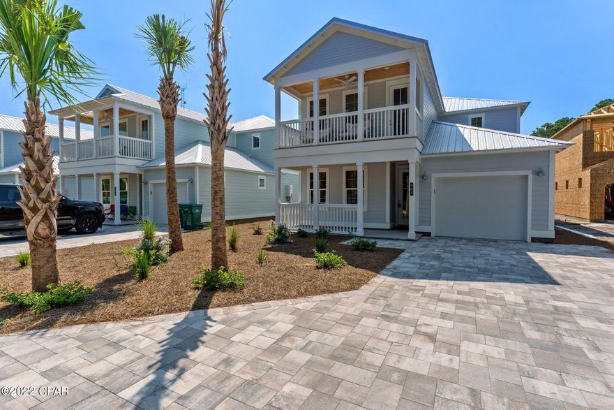 This new construction vacation rental is projected to produce over $150K-$200K in base rental income. Enviably located next to Pier Park shops, restaurants and outdoor activities, this surprisingly spacious beach house has porches on both levels. Constructed less than a year ago, the appliances, furniture and fixtures are like new. It has a large private outdoor living area with a pool and six bedrooms to accommodate up to 20 guests. It's ideal for vacation rentals when not in use by the owner. What's more, this beautiful beach home is just three minutes from the beautiful white sands of Panama City Beach. The interior decor is to the highest standard with handpicked designer wallpaper, tastefully curated furniture and artworks delivering sensory pleasure and harmony throughout the home. The bright open family room is a communal gathering place for meals and social chatter. Throw open the French doors and enjoy pool views from the deep, cushioned sofa and chaise. The private backyard has a heated pool for hours of pleasure and the covered deck with its tie-back curtains creates a comfy gazebo-style living area for sharing drinks, chatter and laughter. There's a well-laid-out kitchen for large-scale cooking with a lengthy island breakfast bar that doubles as prep and serving space. Six generously sized bedrooms, each with its own character and smart TV, allow everyone to enjoy their own private space. Make use of the garage for storing beach chairs and bicycles. There's ample parking for vehicles on the paved driveway. All this, just a short walk from the stunning white sandy beach.