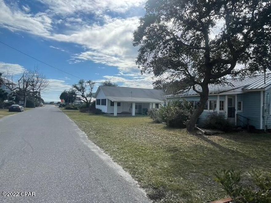 Build your dream home at the beach!  Wonderful opportunity to design and build in the Sunnyside community in Panama City Beach.  Nice level lot just steps to the beach with 2,800 feet of beach front dedicated for the residents of Sunnyside.  Located between popular Pier Park to the east and 30A to the west, this homesite is just a short drive to the many shops and restaurants these areas have to offer. Great rental potential.  Enjoy the famous beaches of the Emerald Coast just down the street! There is small home on property (2 bedroom/1 bath) built in 1946 and another structure with a guest cottage and garage. Property also has a septic tank.  All are ''As-Is''.  Seller makes no representations about the property and Buyer to verify all needed info through due diligence.