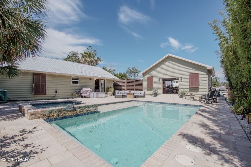 Your own private compound and tropical oasis awaits! Just a short walk to the beach and even shorter walk to a boat ramp on south Lagoon you will not find another property like this one! The home has been meticulously cared for and updated featuring 3 beds, 2 baths with a spacious open floor plan. The back yard boasts a luxurious pool with bamboo, lush landscaping, and an 8ft privacy fence offering the ultimate privacy. The property also features a detached garage/workshop built in 2022 and ample gated parking space for boats, RVs etc. Truly a boater and beach lover's dream home! Come see this one of a kind property today!