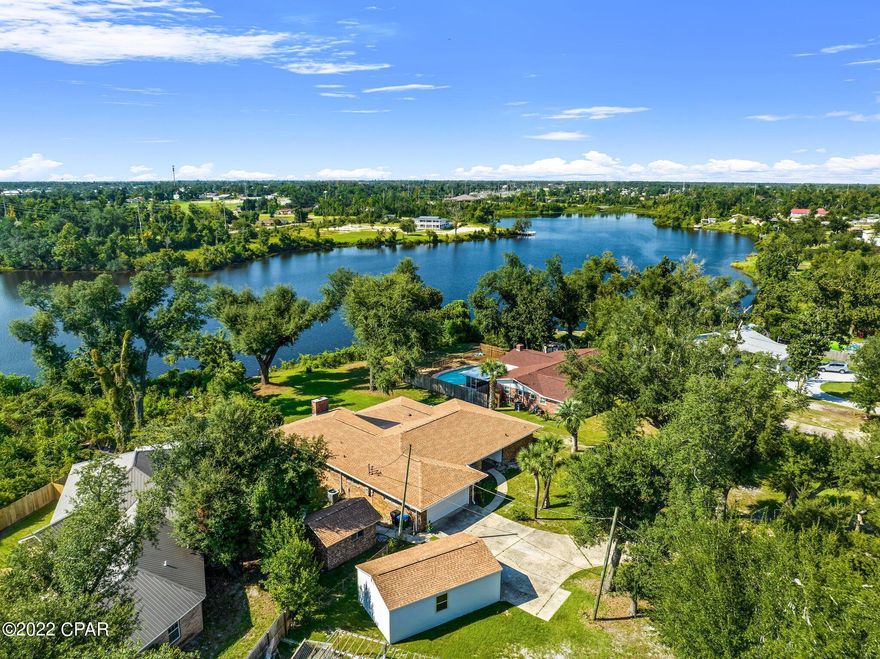 A Stunning Mid Century Modern Waterfront home, Completely Renovated! for the extra toys, there is an extra detached 27x16 shop with 220 installed, & a 2nd 15x12 shop. RV + boat & plenty of guest parking.

All of this and NO flood insurance required This 2,745sf 4-bedroom home features a new roof, all new flooring, New Bathrooms, & new interior and exterior paint.  A New kitchen including quartz counters, stainless steel appliances, custom cabinets & LED lighting. A split bedroom floor plan placing the Water View Owners suite on one wing and the other rooms & bath on the other. See more remarks As you enter, you gaze through the vast living room past the massive Florida room, over the rear yard perfect for a pool and down to the private water view of Lake Martin. To your left is a dining room to accommodate 12, across from that is your modern kitchen + family room w/an open great room feel that connects with all the guest bed's, bath & Florida rm