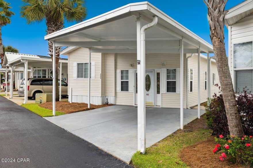 Emerald Pointe is a beautifully landscaped, gated community on Panama City Beach. There are 296 park model cottages; amenities include a large clubhouse, two pools, hot tub, fitness center, a pet walk, shuffleboard, boardwalk and is a golf cart friendly community. Located close to fabulous restaurants, shopping, marinas, St. Andrews State Park and our famous sugar white beaches. This well maintained 3 bedroom, 2 bath home includes a large master bedroom with a walk-in closet, 2 additional full sized bedrooms, a spacious living room, kitchen/dining room, utility room and attached 2-car carport.  Built in 2005, the home has never been a rental property.  Updates include a shingle roof in 2016 and a new HVAC installed July 2023. The Seller is offering a $3,500.00 flooring allowance to a Buyer with an acceptable offer.  This home could be your primary residence, a personal vacation home or an investment property. All information and measurements are approximate and should be verified by the Buyer.