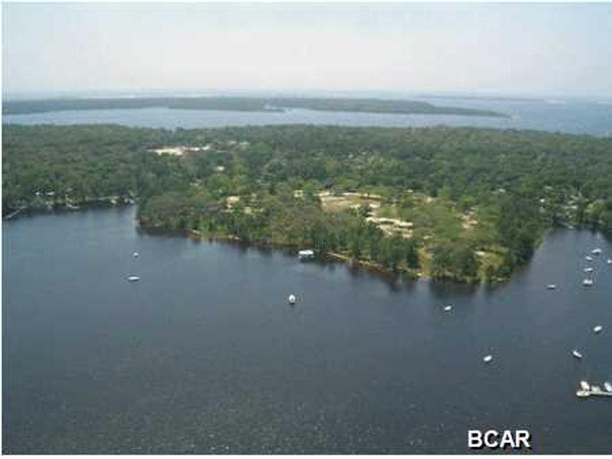 This beautiful WATERFRONT home site is located in Cove Pointe, an attractive community within the Cove area of Panama City. Cove Pointe was developed on the shores of Watson Bayou, a navigable waterway which provides direct access to St. Andrews Bay, The Gulf of Mexico and inter-coastal waterway. The close proximity of Cove Pointe to the deep water channel leading to the Gulf of Mexico, unrestricted by bridges, makes the area one of the most desirable locations for boaters. Cove Pointe is a small and unique community with an interesting history. The area is close to downtown Panama City, Bay Medical / Sacred Heart Medical Center, marinas and many downtown attractions, as well as the nearby St. Andrew Bay Yacht Club. Cove Pointe and the Cove area of Panama City are known their many beautiful and mature hardwood trees, an impressive property elevation and very convenient location. Cove Pointe has become one of the most desirable places to live in the Panama City area. More information on the community, covenants and activities of the Owner's Association can be found on the CovePointe website.