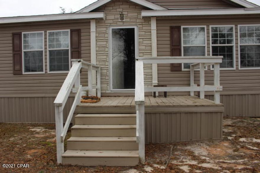 Under Contract - Taking Backups the phrase 'CURRENTLY UNDER CONTRACT, SELLER ACCEPTING BACKUP OFFERS'.  Are you just starting out or looking for a winter home in Florida, this move in ready  home will be left furnished.  Seller is just taking a few personal items and the rest is yours.  Well cared for clean home has a split bedroom floor plan, fireplace in living room, eat in kitchen, and all the whirlpool appliances stay along with the washer & dryer.  You are going to enjoy some outdoor entertaining on the back decks.  There's room for a garden. You'll be living in the country but not too far of a drive into town for shopping and it's just a 45 minute drive more or less to Panama City.  Read more remarks... There's a workshop attached to the carport that has electric plus another additional building was custom built to include windows all around the whole building which the seller uses for entertaining.  The HVAC replaced new when purchased in 2013.  New roof after Hurricane Michael.  All bedrooms have walk in closets. Pantry in the kitchen. Mop sink in laundry room. Garden tub and separate shower in master bath along with a large walkin closet & double vanity sink.