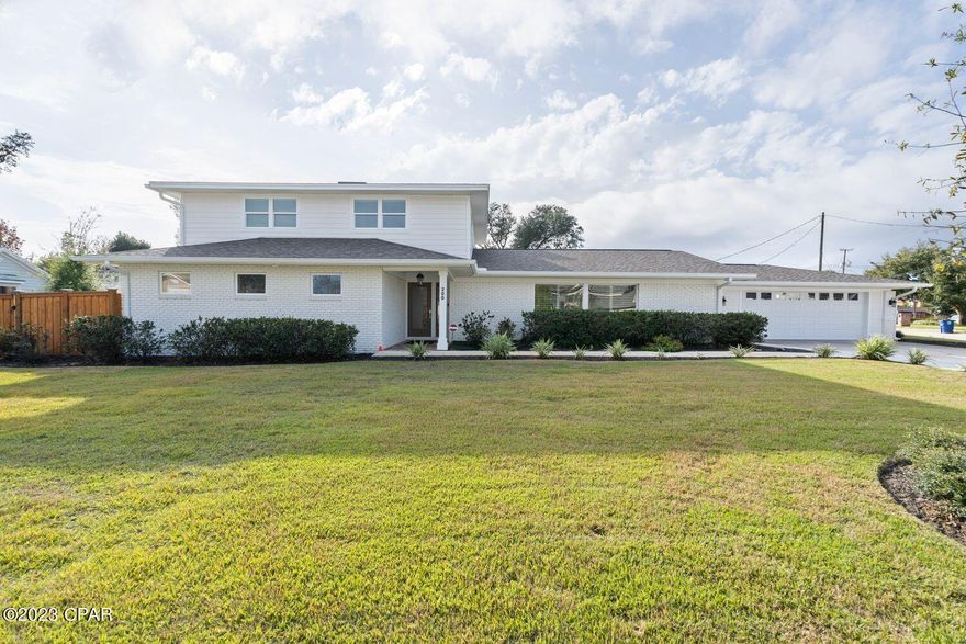 CURRENTLY UNDER CONTRACT, SELLER WILL CONSIDER BACKUP OFFERS. Welcome to an incredible opportunity to own a home in the heart of the Cove neighborhood, across from the Bay on a corner lot. This home is a rare find in the Cove and features a gorgeous saltwater-heated pool/spa, 2-car garage and over 3,500 square feet of living space. With 4 bedroom, 3 full bathrooms and 2 half baths, this fully-renovated home offers ample storage, large closets, oversized bathrooms and high-end features throughout. 

Step into the entryway and you're greeted by an open concept with consistent flooring throughout, a large kitchen island, a brick-clad fireplace and large windows flooding the great room with natural light. This home was designed for entertaining! The expansive kitchen features an abundance of custom kitchen cabinets, granite countertops, Kitchen Aid and Frigidaire Professional appliances, a full-size walk-in pantry, wine refrigerator and a large kitchen island open to the living room and dining room. The living room with a brick fireplace features double French doors that lead to a covered patio and a stunning saltwater-heated pool and spa. The oversized great room has an accessible powder room for guests and also allows for a sitting room, additional family room and is open to the dining room, just off of the kitchen. 

The main level offers a primary suite with French doors leading to the patio, a large walk-in closet with custom built-ins and a spacious en suite bath. The en suite bath has a walk-in tiled shower, separate soaking tub and double vanities with quartz countertops. The upper level offers 3 additional bedrooms, two full baths and a half bath. This is an incredible option for guests or family members who share a bathroom with 3 vanities available on the same level! One bedroom has an ensuite full bath and a large walk-in closet with built-ins. Two guest bedrooms share a full bath and powder room accessible by the hallway. Consistent flooring throughout the upper level creates a great flow for the home. The bedrooms upstairs also offer great views of the Bay! 

The backyard is a true oasis! The covered porch is great for entertaining and there is the ability for an outdoor brick grill behind the fireplace. Imagine cooking s'mores and watching the kids play in the pool year-round. With a heated pool and spa, you will enjoy this great amenity with your friends, family and neighbors all year long! The corner homesites allows a large yard with lush landscaping and sod. A unique feature of this home is also a climate controlled storage room, accessible by the back yard. This gives the option to store items or also expand the primary bedroom walk-in closet for additional space or a larger laundry room. Possibilities are endless!

With a full interior renovation in 2021 and a full exterior renovation in 2022, this Cove home has been completed remastered! 200 Hollis Avenue has a freshly painted-white brick exterior, a unique and super functional drive-through 2-car garage and a luxurious pool. Extensive landscaping has been added to the home and a lovely addition of mature oak trees complement the Cove neighborhood. There is a shallow well, an irrigation system with 4 zones and new pool equipment this past year. HVAC system is 2020 and a new tankless hot water heater was added this year. 

The Cove is a well-established neighborhood covered with hundred year oak trees and lovely neighborhood parks. The City of Panama City is replacing the infrastructure under the roads in the neighborhood and Hollis Avenue is scheduled to be complete within the month! With no HOA, this is a great place for those who wish to have all the toys, for kids and adults alike. This is a great opportunity to live in the Cove!