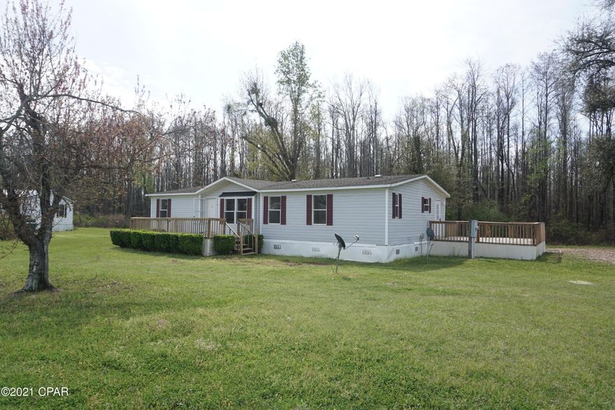 Spacious 3 bedroom, 2 bathroom doublewide mobile home on 2.25 acres. This open floor plan home features a large kitchen w/ freshly painted cabinets & extra shelving for storage. All of the carpet is brand new. Master bedroom has an en suite tiled bathroom w/ double vanities, garden tub & separate shower. There is also a walk-in closet in the master bedroom. There is large back deck perfect for grilling. The HVAC unit was replaced in 2017. The home is in close proximity to the town of Grand Ridge, Sneads, Marianna.  FHA-96.5% or VA-100% (for Veteran buyers) financing available through Michael Walden with Cardinal Financial. Email is michael.walden@cardinalfinancial.com; phone is 334-806-6622  Seller open to consider all reasonable offers. Seller will reimburse buyer's home inspection up to $300 at closing. (must purchase home to receive the reimbursement)