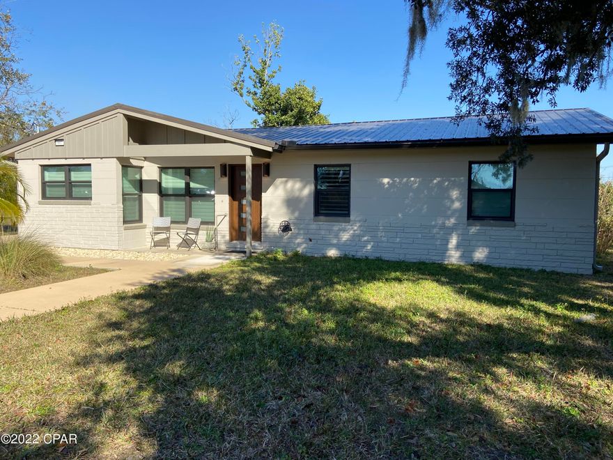 Home was completely renovated after Hurricane Michael.  Essentially all interior walls removed and built from foundation up.  Home design is mid century modern with upgraded appliances, floor coverings and finishes.  House is completely handicap accessible with a ramp onto the back patio which access the house.  Master bedroom features a spacious sitting area.  Master bath has a large walk in shower,  Kitchen has an induction cooktop, and large single bowl sink.  2nd bedroom has vaulted ceilings.  Back deck is 18 x 32