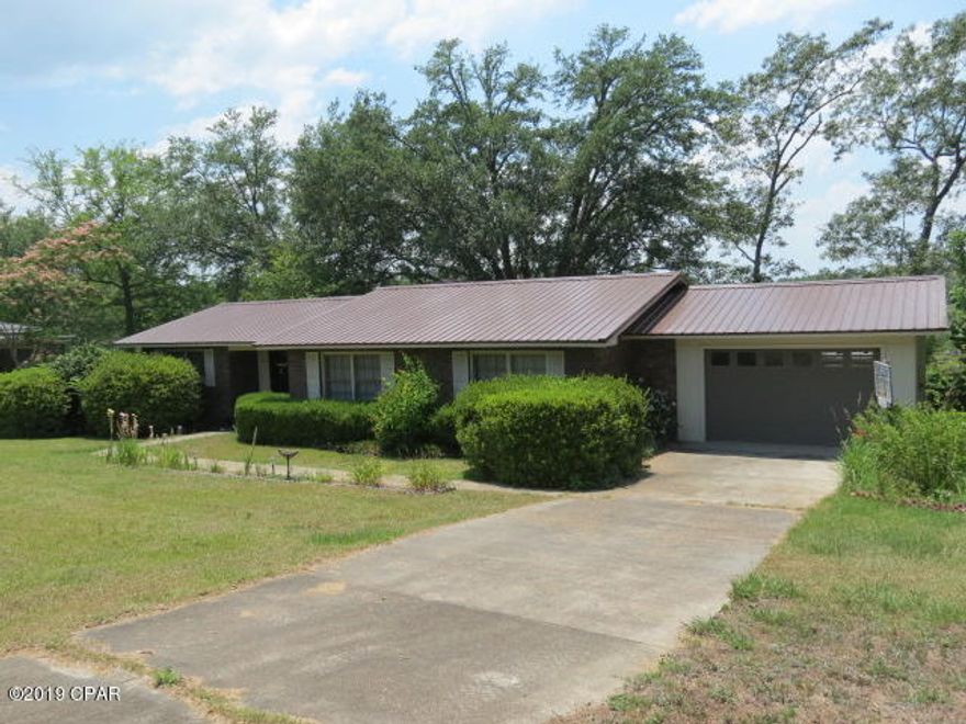 CURRENTLY UNDER CONTRACT, SELLER ACCEPTING BACKUP OFFERS! House sits on Beautilful Dogwood Lake. Across the road from the Golf Course with a driver range. Beautiful brick covers the main part of the house. Great room sits on the back so you can sit in your favorite chair and look at the water while enjoying a beautiful fire in the fire place. Brick patio on the back has a built in grill. Updated kitchen which also overlooks the water. House has tiled floors. With a little paint inside this would be the perfect place to retire or build your family. NEW METAL ROOF! A MUST SEE! Progress has been made to repair the lake.