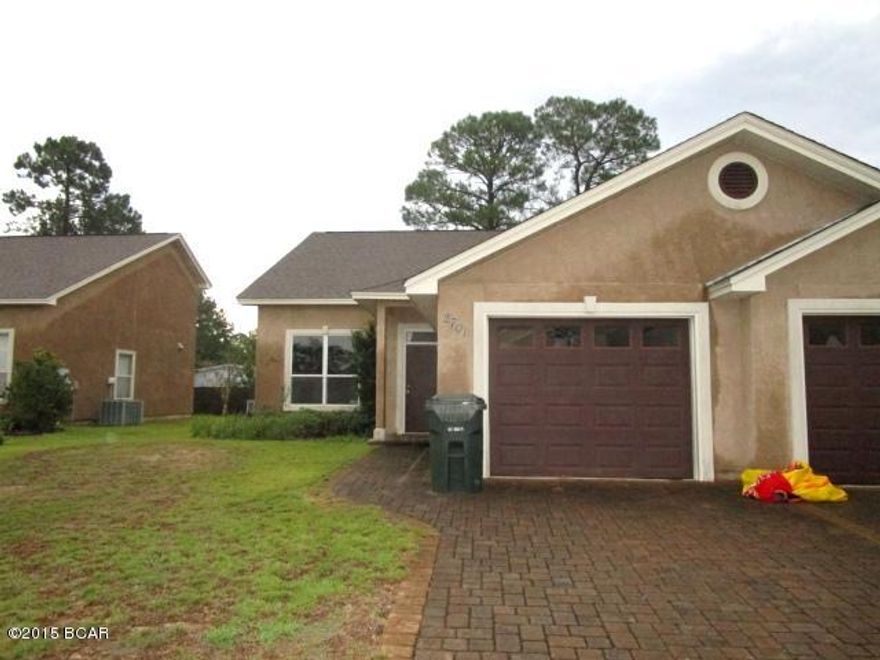 ATTRACTIVE TWO-STORY TOWNHOME close to Lynn Haven and move-in ready!  This home features a living room with vaulted ceilings, a spacious kitchen with solid-surface counters and stainless steel appliances, and an eat-in dining area.  The Master bedroom is on the first floor and has a Master bath complete with a whirlpool tub and walk-in closet.  Two bedrooms and a full bath are on the second level.  The home has a one-car attached garage and partially-fenced yard.  Home being sold in its AS IS condition.