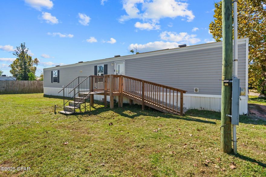 Move-in ready 2019 mobile home on a 0.142-acre lot featuring a split bedroom floor plan for added privacy. The primary suite includes a walk-in closet and a full bathroom with a bath tub. The kitchen offers a breakfast bar and black appliances, including a dishwasher, and opens to a cozy living area. Additional highlights include an updated hot water system (2025), a laundry room, and a convenient circle driveway. The property also offers a great-sized yard with a large storage shed—perfect for outdoor projects or extra storage.