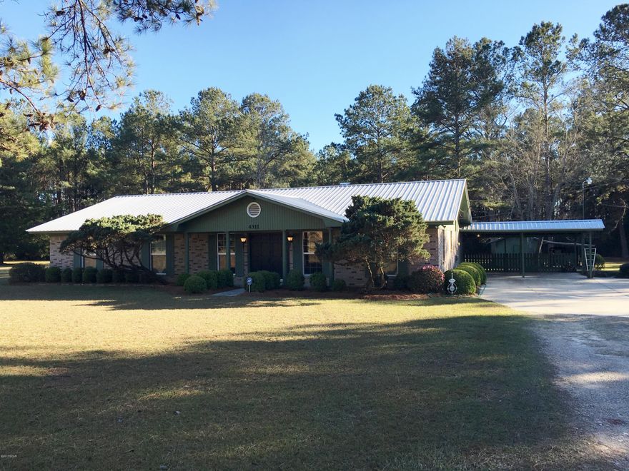 Located 2.5 miles from Downtown Marianna and sitting on 8.84 ACRES is this recently updated 3BR/2.5B, 2257 H/C sq ft home. Upgrades include 30 year metal roof, interior and exterior paint, double pane windows, kitchen cabinets, sink, Pantry and new splash guard under the countertops, stainless appliances, flooring throughout, all bathrooms have been remolded, 2 water heaters, Sheetrock replacing panel, and much more. The home has a large family room with fireplace, insert and laminate wood flooring. The bonus room is tongue and grove pine boarding and laminate wood flooring. The spacious master bedroom has 3 closets, remodeled bathroom and new carpet. All the bedrooms have new carpet and are spacious. The laundry has shelving a a half bath. Please see more remarks. The house is in a beautiful setting surrounded by large pine trees and spacious yard. There is a 2 car carport with a large covered patio and water fountain that is great for entertaining or just sitting back and enjoying nature. There is a utility house for storage and a larger shelter enclosed on 3 sides for men's toys or storage. Behind the house is a small wet weather creek that runs through the property. The home and property is located on a quiet, dead end street with a large tract of pine trees bordering the west side of the property. Plenty of room for horses or pets.