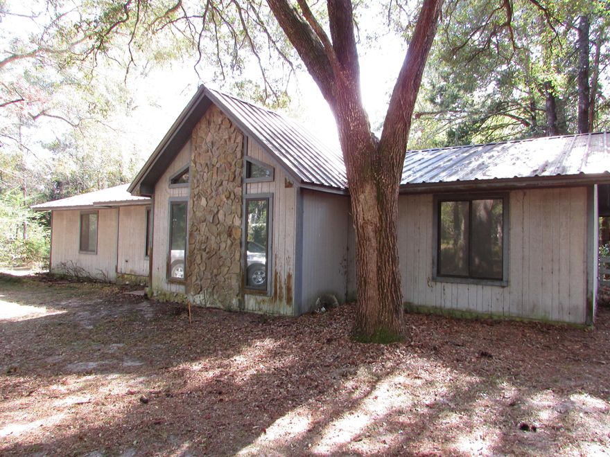 WOW.. Take a look at the price of this Pool Home!! Located in Marianna this 3 Bedroom 2 Bath home has 1497 Sq ft under air sitting on 2.06 acres!! Wood burning fireplace, vaulted ceilings, central AC. Relax in the Florida room overlooking the pool area!  There is a in ground pool and fenced back yard. Home needs some work but could be a perfect home for you!  Call today because this home will Sell Quickly!!