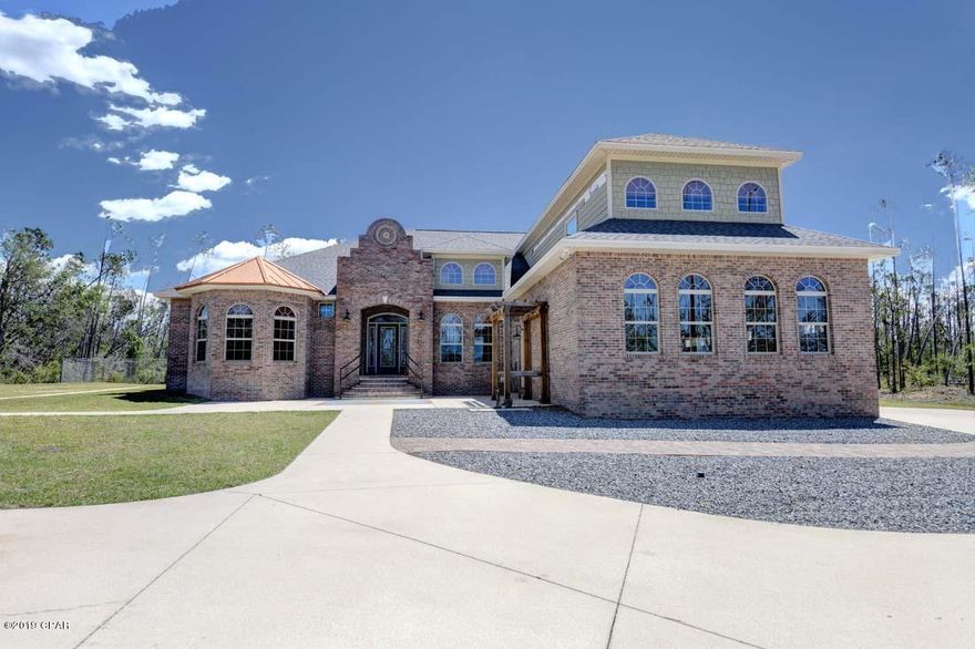 'CURRENTLY UNDER CONTRACT, SELLER ACCEPTING BACKUP OFFERS' SIGNIFICANT PRICE REDUCTION! This home received NO structural damage from Hurricane Michael. The missing siding and fascia in the photos has been replaced and the roof is brand new. This beautiful custom-built home is truly an artistic masterpiece.  Designed by the homeowners, the details of this home have been well thought out and planned. Artistic touches include the copper roofing over a rounded bank of windows on the front of the home, a mosaic inlay above the outside entrance, and a mosaic above the kitchen sink designed and made by the homeowner (the four birds represent the four children of the homeowners). The massive gourmet kitchen has professional appliances ( brand new double oven and large commercial refrigerator/freezer). The kitchen opens into the great room with many furniture arranging options and leads to a Florida room with a brick oven/fireplace. There is a sitting area to the right of the kitchen, and an inset room large enough to fit a 12-seat dining table. The kitchen and utility room have storage galore, and the utility room includes an ice maker, perfect for dinner parties or days out on the water. Off the great room is a nice sized office, which leads into the Master Bedroom. There are his and hers closets, and a gorgeous bathroom with a tumbled marble walk-in-shower, deep soaking tub, and separate water closet. Off the Master Bath is a nursery or additional office, sitting room, or spare bedroom. On the other side of the home you'll find three additional bedrooms, a Jack and Jill bath and a half bath. Venture upstairs and you'll be greeted by a large media room which could also be a teen or college students' bedroom, or a game room. It includes a handy sink and refrigerator area. There is a half bath off the hall and two large storage closets. The home has a three car attached garage. Outside of this custom-made home you'll find an 800sf AC/Heated workshop with a single car garage door access and a front patio. This great space can be a workshop, or it could be converted into a Mother-in-law suite, an AirBnB, or a college student's flat. Behind the home is a gazebo, great for enjoying peaceful evenings. The original and only owners of this home loved the outdoors and spending time with their family. Come out and see this home, it is waiting and ready for you and your family to create more memories within its walls.