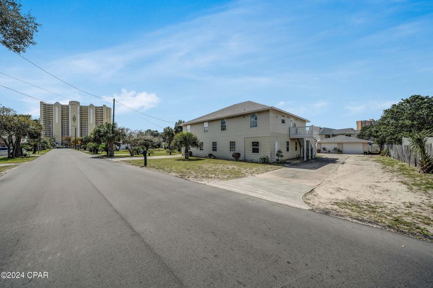 REDUCED $100,000.00 Here is your opportunity for an investment that is a one block walk to the beach and allows short term rentals with no HOA. This is a triplex  with 2 units upstairs and 1 unit downstairs. Upstairs is a 2 BR/2 bath on one side and a 2 BR/1 bath on the other side. Downstairs is 4 Bedrooms and 2 baths. Great location at quieter west end. Very very short walk to beach. Walk to Salty Sue's to eat and Mike's Diner. Short drive to Pier Park. Another option you could live in one unit and rent the other units out. Each unit upstairs has its own entrance and downstairs unit has 3 entrances. All measurements are approximate. Verify if important.  I have a rental projection of 136,715 per year. Each unit has it's own entrance..