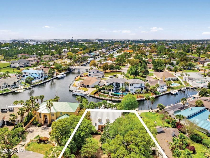 Located in the gated community of Bay Point, 1102 Redfish Circle offers an exceptional waterfront lifestyle with 80 feet of deep-water frontage and direct access to St. Andrews Bay, the gulf, and the Intracoastal Waterway. This three-bedroom, three-and-a-half-bath home spans 2,771 square feet and is ideally positioned on a quiet street before the neighborhood bridge, providing convenient boating access and a prime location within the community. Designed for both comfort and entertaining, the home features spacious living areas filled with natural light and beautiful water views throughout. The layout is thoughtfully designed, with a primary suite on the first floor. Upstairs, there are two bedrooms, each with its own bathroom, along with a second-floor living room for additional space for guests or relaxation. 

Step outside to enjoy your private swimming pool and waterfront setting, perfect for unwinding after a day on the water or hosting family and friends. Boaters will appreciate the easy access to open water and the short ride to Shell Island, making this property a true boater's paradise. The home also includes a rare three-car attached garage, offering ample space for vehicles, golf carts, and water toys, along with a large circular driveway for additional parking. 

Residents of Bay Point enjoy a secure, gated environment with close proximity to Bay Point Golf Club and the popular Bar 72 restaurant. Offered furnished, this home presents an opportunity to step into the waterfront lifestyle from day one.
