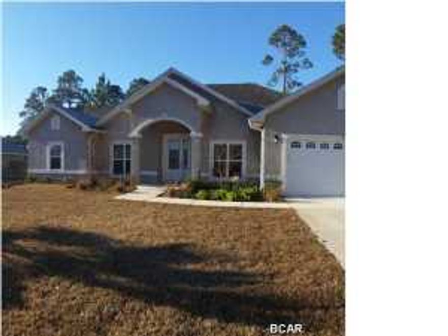 Beautiful Home,located about one mile from Pier Park. Beautiful contemporary home across the street from the bay, in golf course community. This stunning four bedroom three bath home has over 2200 square feet under heat and air and almost 3,000 square feet under roof. Enter the covered front porch to an open floor plan with formal dining room on the right and office on the left and on into the great room which opens to the kitchen area. The well equipped kitchen features stainless, energy efficient appliances, solid wood 42'' cabinets, granite counter tops,brushed nickel faucets,and an island breakfast bar with pendant lights and walk-in pantry. The master bedroom features crown molding a sitting area and recessed lighting. Master bath boasts separate tiled shower, garden tub,double