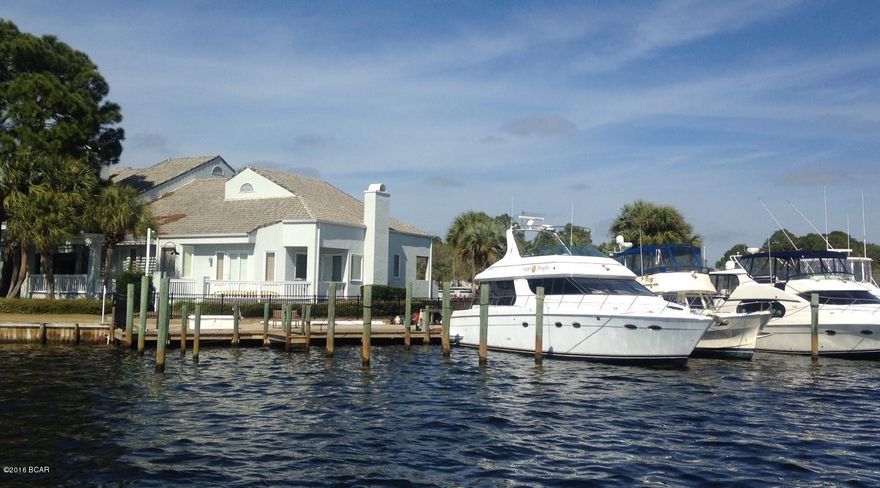 Waterfront Luxury Home/Condo -3 bedroom and 2 bath, inside Bay Point's Golf Cart Community. Get the feeling of a Grand Home with the amenities of condo living. This is ''The End Unit'' in Marina Club Village with the best views of Grand Lagoon and Bay Point Marina just a short walk over to Club 19 and the golf course. Current owner is still holding your marina slip for your yacht so come by land or sea to preview this stunning home.  Featuring 20 Feet Ceilings, three layer crown molding, custom wood work, speciality lighting, plantation shutters throughout. Beautiful kitchen with Granite & Stainless GE Appliances and ice maker, marble tile and Bose sound system.

You can watch the fabulous sunsets from the DOUBLE SIZE decks that wrap around from the Master Bedroom to the Great Room.