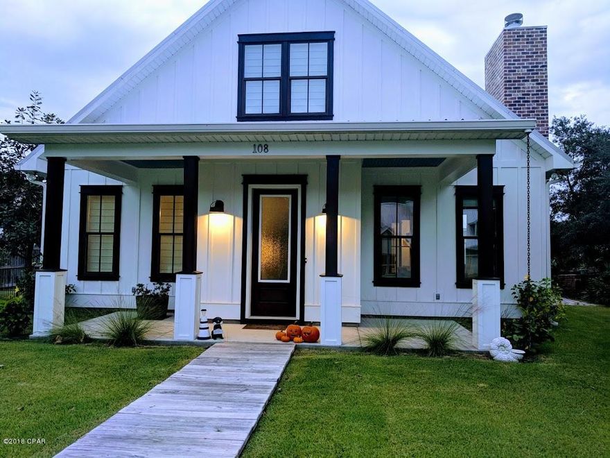 Amazing find for this like new Florida cottage style home, and only a short walk or golf cart ride to the Gulf. This home features a covered front porch over looking a well manicured lawn on a corner lot.  The kitchen and living room are open and airy with a center counter/bar area and fire place in the living room.  The dining room includes a sliding farm style door over looking a courtyard.  The master bedroom is on the first floor as well as the office/nursery and laundry room.  There are two spare bedrooms and bathroom upstairs.  There is a detached garage with room for storage and additional drive way parking for 2.