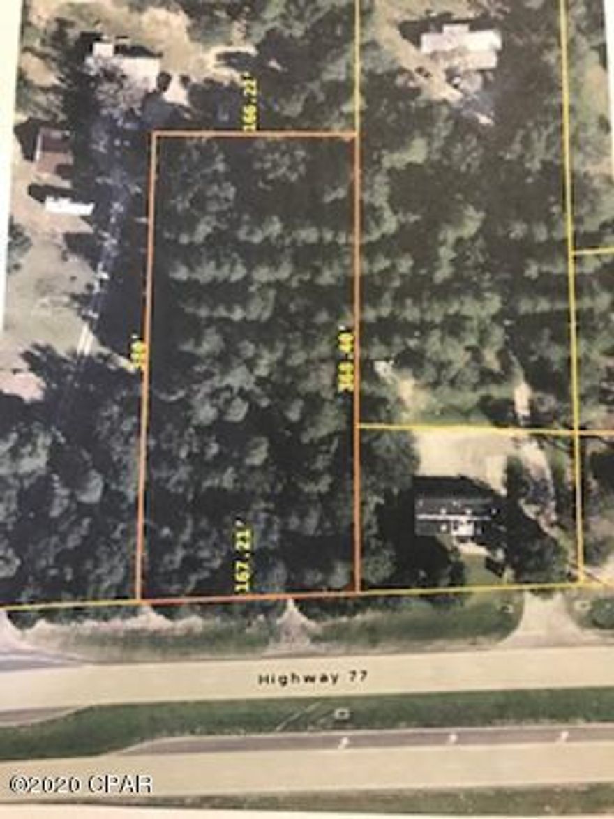 1.4 acres of commercial land with 167 feet fronting Hwy 77.  Lot has numerous hardwoods and prime timber.  If required or desired, Seller is offering financing at 20% down, 6% interest with a 30 year term and 10 year balloon.  Listing Broker is related to Seller.