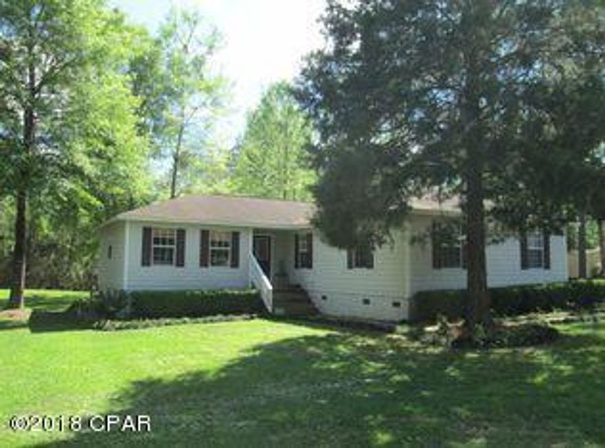 This house sits nestled in gorgeous magnolia trees. The split bedroom floor covered in vinyl plank is the perfect home. The master bedroom offers a full walk-in closet with double vanity and solid oak cabinetry. A cook shed outside is wired for electricity. There is a 1200 ft. deep well and the septic is only 4 years old with a grinder pump. Relax on your porch and enjoy this acre lot and all this home has to offer.