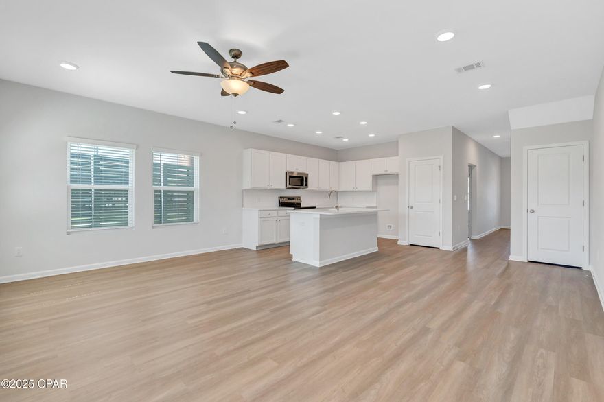 NO RENTAL RESTRICTIONS!!! End unit! Check out the open green space behind this townhome!!! Waypoint by Traton Homes, a vibrant new community of townhomes located on Front Beach Road in Panama City Beach, Florida. Waypoint offers 72 homes just under 3 miles from the beach, 1.5 miles from Dolphin Bay, and approximately 20 miles from the Northwest Florida Beaches International Airport. Residents will enjoy easy access to local attractions, with Pier Park only 7 miles away and Hathaway Bridge nearby, serving as the gateway to Panama City proper. The community is also conveniently situated near the Naval and Coast Guard bases.  Each townhome features 3 or 4 bedrooms, including a bedroom with a full bath on the main level. The open concept living space includes a modern kitchen with an island, a dining area, and a family room that opens to a private back patio. Upstairs, the spacious owner's suite offers a walk-in closet, and an ensuite bath with a double vanity, a shower, and a separate water closet. Two additional bedrooms, an additional full bath, and a conveniently located laundry room complete the upper level.