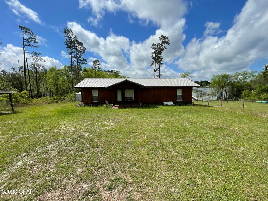 Waterfront on Compass Lake!  Cute little cottage/cabin with a dock and access to beautiful Compass Lake.  This cottage has 2 bedrooms and 2 baths and is being offered fully furnished if desired.  Enjoy entertaining on the large screened in porch.  Fish off the dock!  Approximately 135' of waterfront access.  This will not last long!