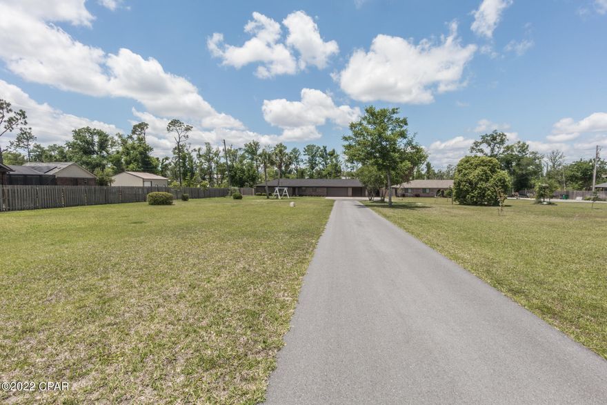 CURRENTLY UNDER CONTRACT, SELLER ACCEPTING BACKUP OFFERS.So much extra space offered with this secluded brick home situated on 1 acre lot on a private paved road that has easy access to schools, Tyndall and shopping. Kayak, paddleboard or small boat fun with the access to the gulf or endless fishing right from your own back yard! 

Over 3000 SqFt under the roof includes 1900 SqFt H/C open concept living space with split floor plan and 1200 SqFt of garage, carport and workshop space.New updates in 2020: New bathroom and walk-in closet in the master suite, new H/C system including ductwork, new ceilings, new insulation, new flooring, 50 amp RV service and so much more. New roof in 2018 after Hurricane Michael. House is on deep well and septic system. Water system is leased, it is $65 monthly. This home was renovated for the family with love, but family outgrew the home, so this is your chance to walk into move-in ready house with quality upgrades!