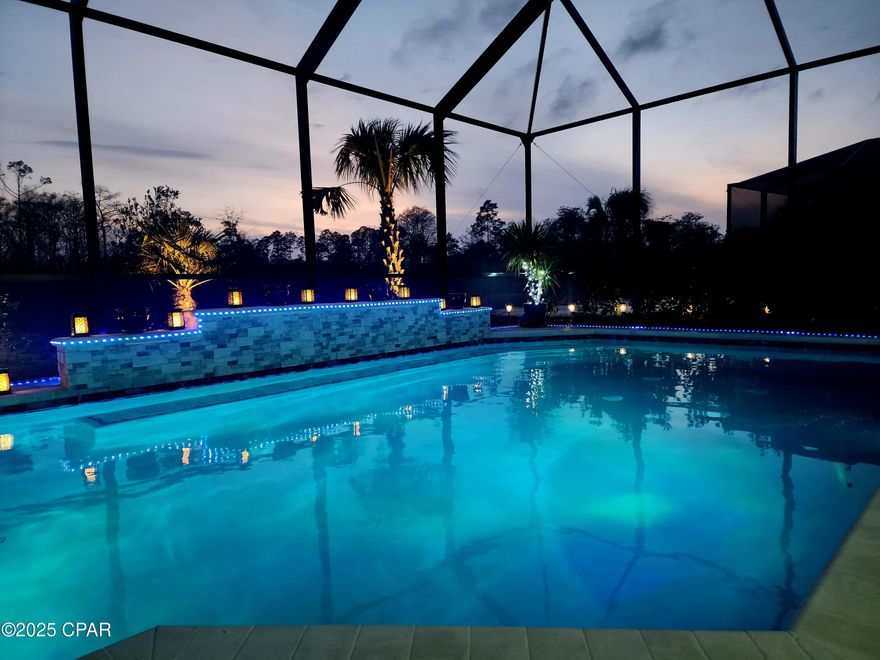 CURRENTLY UNDER CONTRACT, SELLER WILL CONSIDER BACKUP OFFERS.
Now is the Time to Make Your Move!
Exquisite Coastal Living in the Highly Desirable Latitude Margaritaville - 55+ Community. Welcome to luxury coastal living in the highly sought-after Latitude Margaritaville! This Cabana Bay model from the Beach House Collection offers an expansive 2,394 sq. ft., featuring three bedrooms, 2.5 baths, and an array of high-end upgrades that set this home apart.
Exceptional Interior Features From the moment you step inside, you're greeted by an open-concept living space designed for both relaxation and entertaining. The oversized bar and kitchen area are a true showpiece, boasting Level 4 Cambria Montgomery countertops—a premium touch that extends throughout the entire home. Every detail has been thoughtfully upgraded, including: Luxury coastal-color laminate flooring throughout the living spaces, Tile flooring & floor-to-ceiling tile upgrades in the master bathroom, Crown molding throughout the entire home for a polished look, Mirror backsplash in the kitchen to enhance the light and airy feel, Soft-close cabinets with pull-out shelves for added convenience, Under-cabinet lighting for a sleek and functional kitchen ambiance, Upgraded plumbing fixtures throughout the entire home, Upgraded ceiling fans in all rooms for added comfort, Walk-in pantry with ample storage, Cabinetry in the laundry room for extra organization Superior Build & Energy Efficiency No detail has been overlooked in this meticulously designed home, ensuring both efficiency and durability: Builders 10 year structural warranty, Impact glass windows, front door, and sliders for added security & storm protection, Insulated impact-glass garage door for energy efficiency, Epoxy-coated garage floor for durability & easy maintenance, Overhead storage in garage plus attic access with a floored storage area Unparalleled Outdoor Oasis Step outside into your private backyard retreat, where you can watch the wildlife or just sit there and relax overlooking the pool and lake. With the preserve located directly behind and beside this property, you will never have neighbors on one side of your house or behind you. Enjoy the beautiful days swimming or just laying in the sun at this incredible custom-designed saltwater pool that was designed for year-round enjoyment. The pool features: Dedicated waterfall feature for a serene ambiance, Ozone filtration system for crystal-clear water quality, Heater for cooler days & nights, Chiller for those hot summer days—ensuring perfect water temperature year-round, Screened in lanai for pest free enjoyment World-Class Resort Amenities
Latitude Margaritaville offers unmatched amenities, creating a vibrant and active lifestyle for its residents: Pickleball, bocce ball, & cornhole courts
Putting greens for golf enthusiasts
State-of-the-art fitness center, Indoor lap pool & whirlpool for year-round exercise,  Private restaurant with three bars for dining & socializing, Resort-style pool with live music daily, phase 2 of the amenities include a full-size theater, woodworking shop, pottery room, business center and community rooms for clubs or social gatherings. Don't forget about the marina that has just broken ground. Not only can you enjoy the lifestyle in the neighborhood, you will be able to ride your golf cart down and step on to your boat and enjoy a short ride through the bay out to the gulf were you can be mesmerized at Shell Island just spending the day watching dolphins, snorkeling or just soaking up the sun. 
Don't have a boat, no worries it is just a short, drive to the emerald green waters of the gulf and the world famous white sandy beaches. This home offers the perfect blend of luxury, comfort, and convenience, all within a thriving 55+ golf cart friendly community designed for an unparalleled coastal lifestyle. The golf cart and furnishings can be bought separately. St