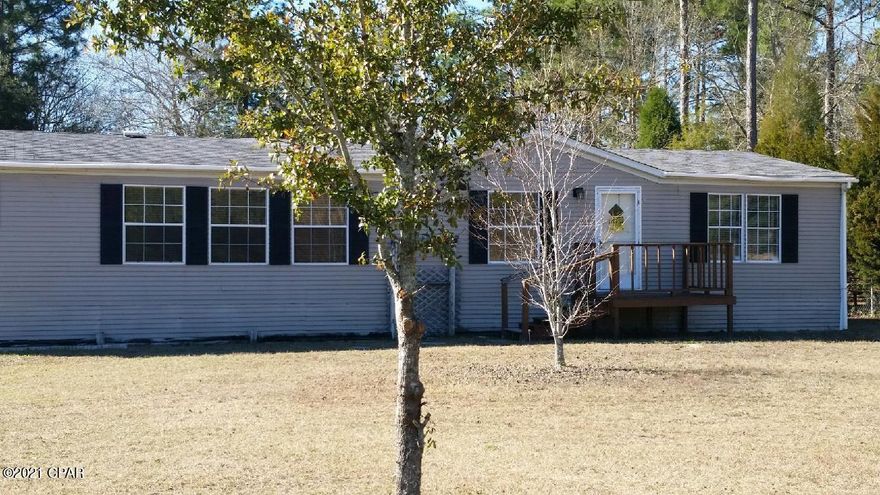 'CURRENTLY UNDER CONTRACT, SELLER ACCEPTING BACKUP OFFERS  pending inspection.  This 3 bedroom mobile sits on a 1/2 acre lot in an excellent location. Convenient to beach, own and Lynn Haven. It has an open floorplan, Vinyl laminate flooring, updated kitchen with all appliances. Sliding glass door leading to large back deck. Large yard building in Yard.  Property is being sold as is. Yard is in process of being cleaned up.