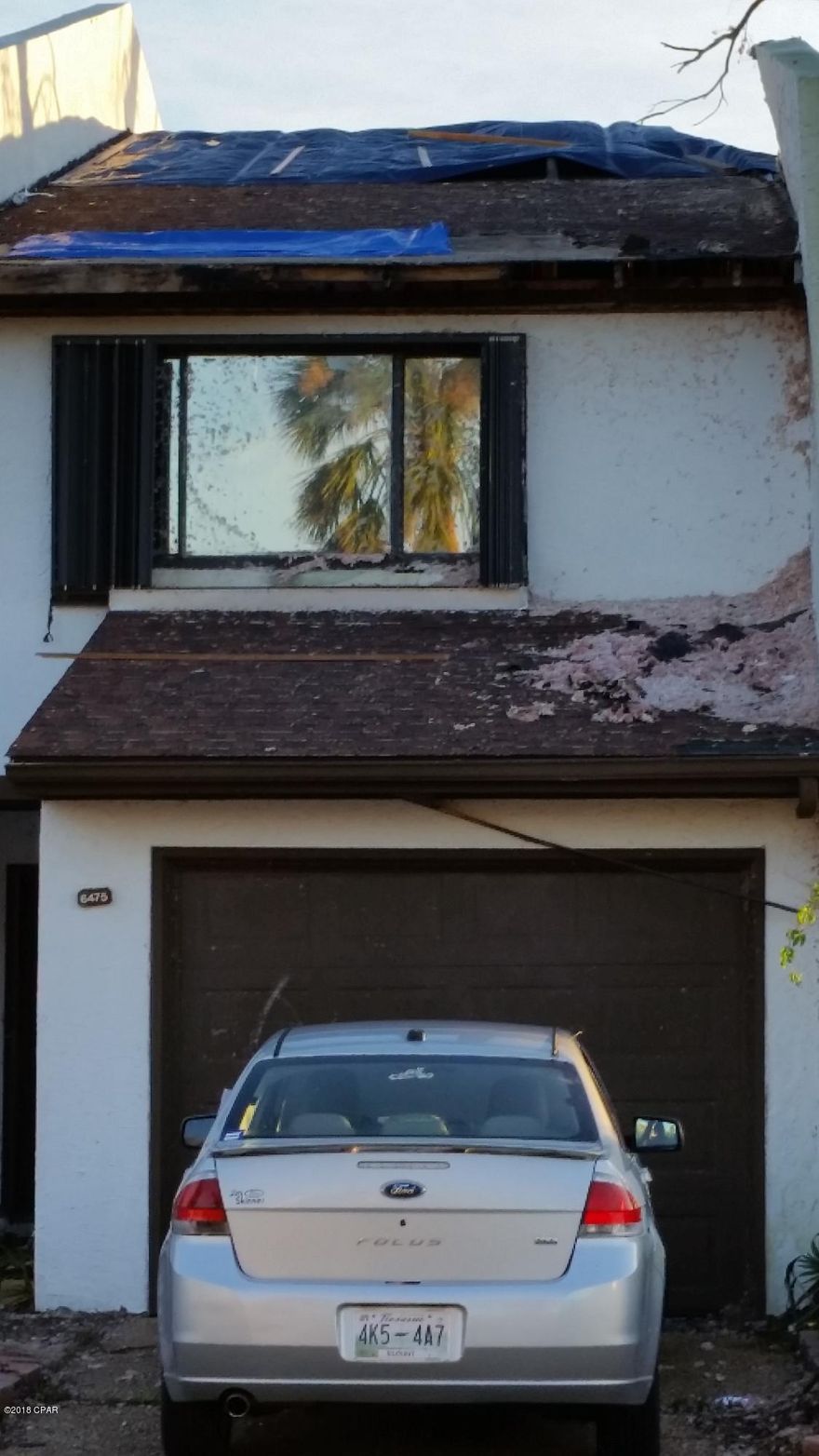 This is a townhouse end unit that suffered hurricane damage.  It is being sold ''as is''.  Needs truss and roof work as well as interior remodeling.  It got beat up pretty bad.  This is a 3/2.5 with great potential. This is a bay front project with access to the bay.  There is also a small park down the street on East Bay.  Tyndall Air Force Base is very convenient being just over the bridge.  Seller got insurance proceeds and wants to get the property sold.