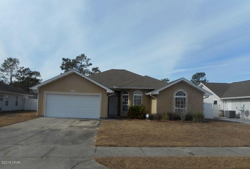 Great home and location in Callaway, FL. This contemporary style home offers spacious living dining kitchen area. Large master bedroom with tray ceiling and master bath with tub, double vanity, separate shower and two walk in closets. There are 3 additional bedrooms and a full bath. Attached 2 car garage. Back covered patio and large fenced back yard with storage building.  Being Sold ''AS IS''.