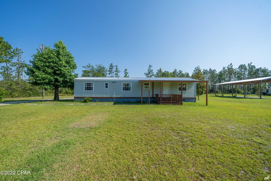 'CURRENTLY UNDER CONTRACT, SELLER ACCEPTING BACKUP OFFERS' Beautifully updated 2 bedroom, 1 bath mobile home with a new metal roof situated on a peaceful 1.7 acres! This property features a new deck, an attached 2 car garage, a 24x48 pole barn with utilities and a shed! This home features an open living room, dining area and kitchen floor plan. The kitchen is equipped with a gas stove and a range hood, an upgraded refrigerator, large kitchen sink, updated cabinets, butcher block counters, an island with storage and modern lighting. The primary bedroom features a built-in safe. The bathroom features a shower/tub combo and an updated vanity. The back deck is perfect for enjoying the Florida sunshine! The 2 car garage is spacious and features built-in shelving and cabinets for storage plus a window A/C unit. Washer and dyer convey.