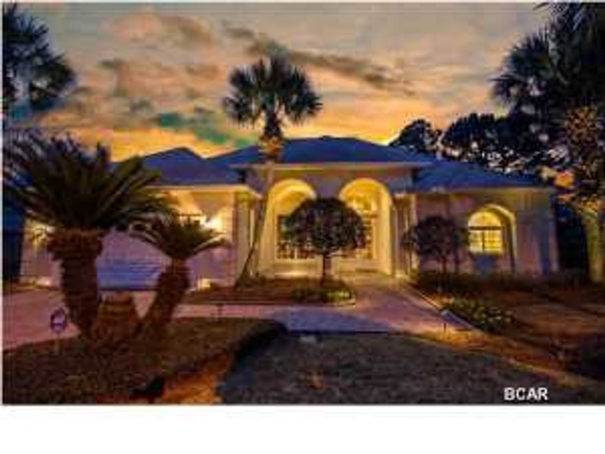 This is a beautiful Bay Point canal home that sits on a lush professionally landscaped yard. This home has won Bay Points' Beautification award two years. You drive up onto a cobble stone paver driveway to the entrance of this all electric 3-bedroom, 2 1/2 bath home. As you go through the double door entrance you are greeted by extra high 14-foot ceilings in the foyer opening up into the living room. Most of the house has large 18-inch double crown moldings to really give it that custom charm. The lowest ceilings throughout the house are in excess of 10-feet with most of them 14-feet. Extra large and numerous 6-foot windows and both interior and exterior transom windows let in plenty of natural light and also offer pool and canal views throughout the whole house. Starting with the