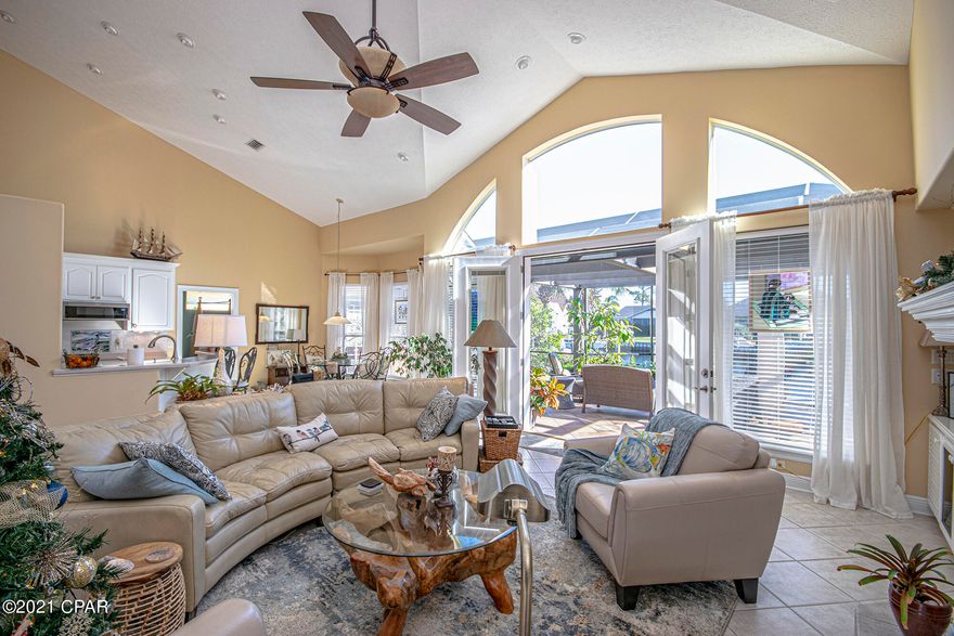 Come and See this Immaculate Ranch Canal Front Home in Prestigious Bay Point gated community.  This lovely home has a newer roof, gutters, windows and doors.  Interior has been freshly painted, updated lighting.  Open, bright and spacious is what you experience upon entering this lovely ranch home.  Dining Room, Family Room, Screened in Porch and Kitchen all open to each other with spectacular views of canal.  Family room has a gas fireplace and built-ins.  Kitchen has southern stone countertops with newer appliances.  Split bedroom floor plan.  Master bedroom suite is a must see.  Extra large garage great for storage and golf cart.  Large Screened in Porch with Upscale Hot Tub included in sale great for entertaining.  Pink grapefruit and lemon tree in back yard.  MUST SEE