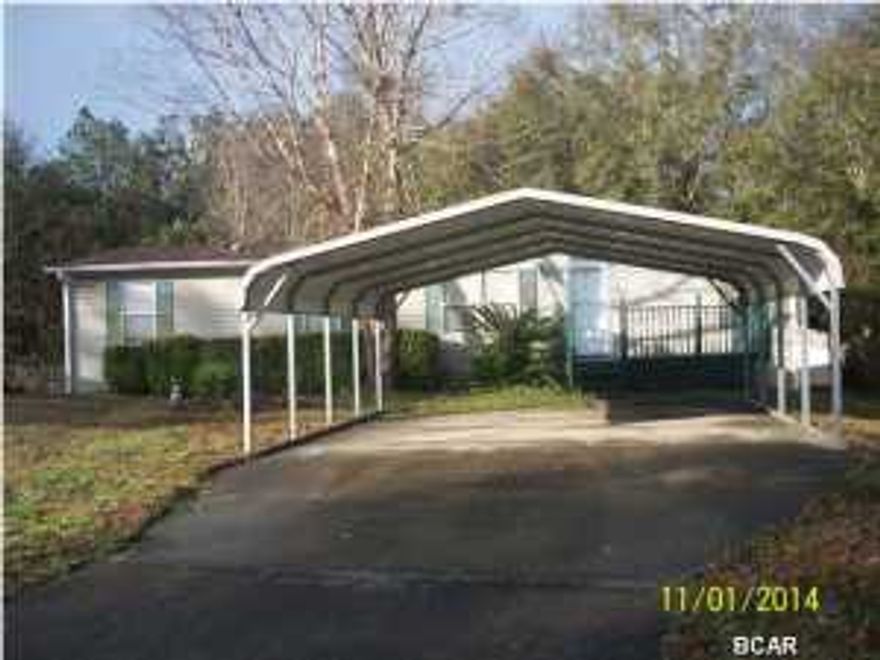 REDUCED!! BRAND NEW FRONT ENTRY AND PORCH $3000 Flooring Allowance with acceptable offer. Great starter home for a great price! Owner occupied since 2003. Mature trees on extra large lot. Great split bedroom floor plan with garden tub in master. Large laundry room and a family room. A workshop and outside storage building This is a quiet neighborhood great price only 8 miles from Panama City and a short a drive to Tyndall AFB. Community offers lake access and recreational facilities for family gatherings. There is a prepaid A/C service that will convey. Septic was pumped in 2013. The owners are motivated and will consider ALL offers!