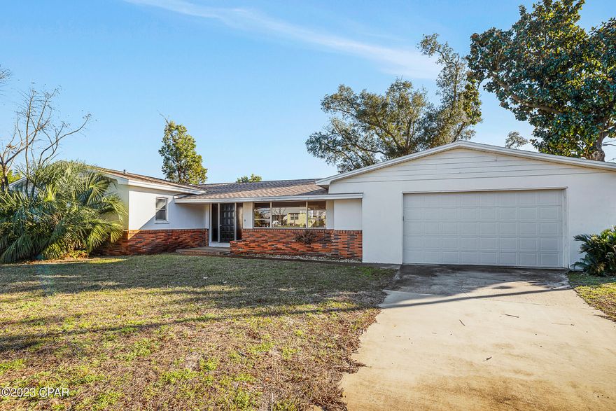 100% FINANCING AVAILABLE with local lender - Property is subject of a court proceeding pursuant to Ch. 64, Fla. Stat., Uniform Partition of Heirs Property Act, with a court-determined value of $229K, & subject to reporting reqs. of 64.111. *** This unique retro home with terrazzo flooring has 3 bedrooms, and 2 full bathrooms with indoor laundry room and attached 2 car garage. The living room features a classic fireplace with a hearth large enough to sit at, and large picture windows facing north providing soft year-round indirect sunlight. The sliding glass door off the dining room leads to the expansive backyard, located on the corner of Kelly Ave and Garden Club Dr. Roof was replaced in 2019. This home sits on 3 lots totaling 0.34 acres. Only 1 block from Bay Memorial Park and just a few blocks from the beaches of St. Andrews Bay, boatable waters, coves, outstanding schools, village shops, great restaurants, and downtown Panama City, FL. All Information is deemed to be reliable, but is not guaranteed, buyer to verify if important.