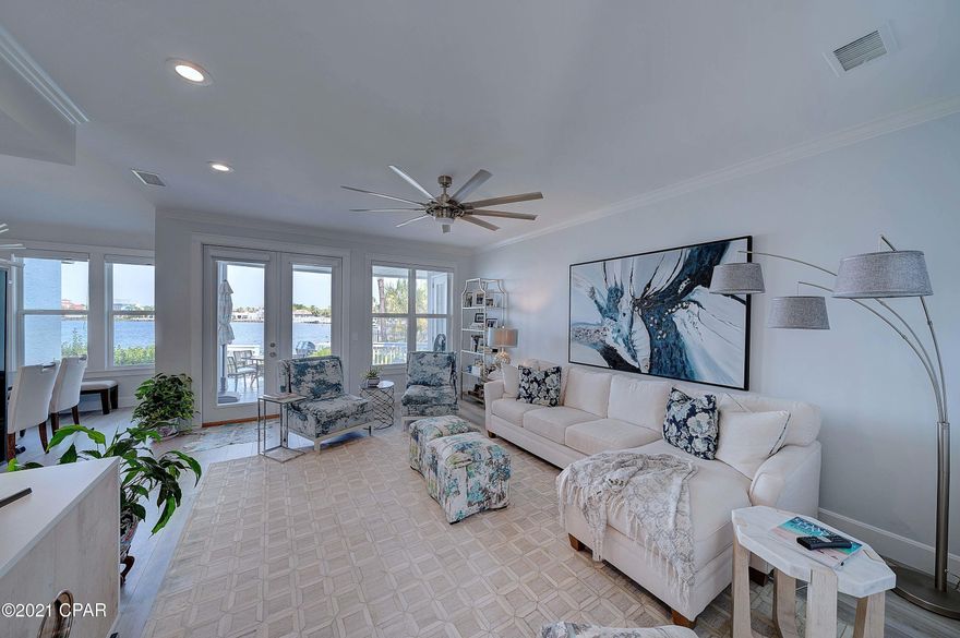 CURRENTLY UNDER CONTRACT, SELLER ACCEPTING BACKUP OFFERS. Waterfront and ground floor in Bay Point! This gorgeous condominium home literally checks all the boxes!  Enjoy single story living, waterfront views from almost every room, a huge back deck overlooking Grand Lagoon, your own garage, a community pool, and a home completely updated from the studs.  There is not an inch untouched with top of the line finishes. including a stunning kitchen, updated baths, floors, fixtures, custom window window treatments, and more.  It has all been done for you, so call today and be ready to move in!  Bay Point is a gated community with tennis, golf, a new marina under construction, and close to grocery stores, restaurants, shopping, and the gorgeous white sand and crystal blue waters of the Gulf of Me