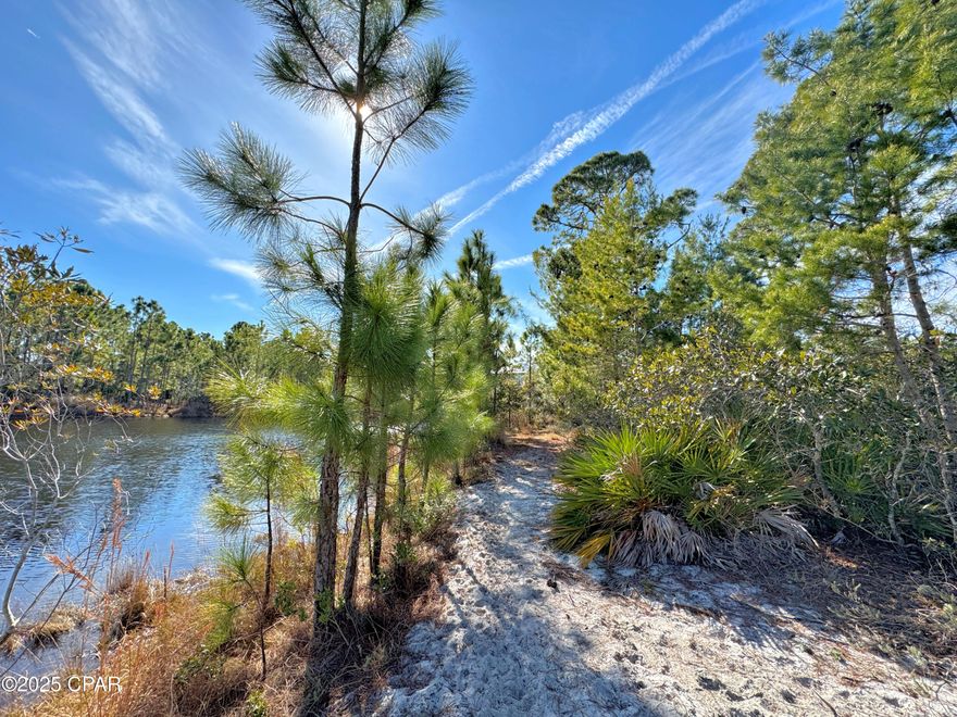 Two affordable lakefront residential lots, low HOA that Seller prefers to sell together for one large homesite. Discover secluded luxury living at Martinique in Panama City Beach, Florida. This exclusive enclave, renowned for its coastal charm and tranquil woodlands, offers a serene retreat that will rejuvenate your spirit. Embrace the essence of Mother Nature and Old Florida architecture in this prestigious neighborhood, where every detail is designed to enhance your lifestyle. Enter through a gated, cobblestoned entrance that ensures peace of mind, and explore winding walking trails that promote health and well-being. Enjoy shared amenities that cater to families, including a stunning pool and play park nestled on the banks of Lake Martinique, the heart of the community. This exceptional double homesite on one of the smaller scenic lakes creates an estate sized parcel and is primed for your dream home. With utility lines already in place and ready for clearing, you can start building immediately. Adhering to thoughtfully crafted building and landscape guidelines, you can maximize the beauty and value of this extraordinary location. Conveniently located just off the bay near marinas, St. Andrews State Park, the pass to the Gulf of Mexico, and the breathtaking beach, Martinique is one of the most unique and sought-after developments in the area. You can walk to nearby restaurants and the exciting Pier Park shopping and entertainment plaza is 10 minutes away. Panama City Beach is buzzing with exciting new attractions set to make waves in 2025! Top Golf is bringing its high-tech, climate-controlled hitting bays to Pier Park, offering a fun and modern golf experience for all skill levels. Dolly Parton's Pirates Voyage Dinner & Show is setting sail with thrilling acrobatics, pyrotechnics, and a four-course feast, making it a must-see entertainment spot. Plus, the highly anticipated Wave Park promises exhilarating water adventures, adding even more fun to this vibrant coastal destination. Whether you're swinging a club, cheering on pirates, or riding the waves, PCB is gearing up for an unforgettable year! Measurements sourced from property appraiser site, verify if important and get a survey. Are you a nature enthusiast, boating aficionado, or beach lover? Let's find out! Don't miss this opportunity to create your perfect sanctuary. Contact us today for more information.