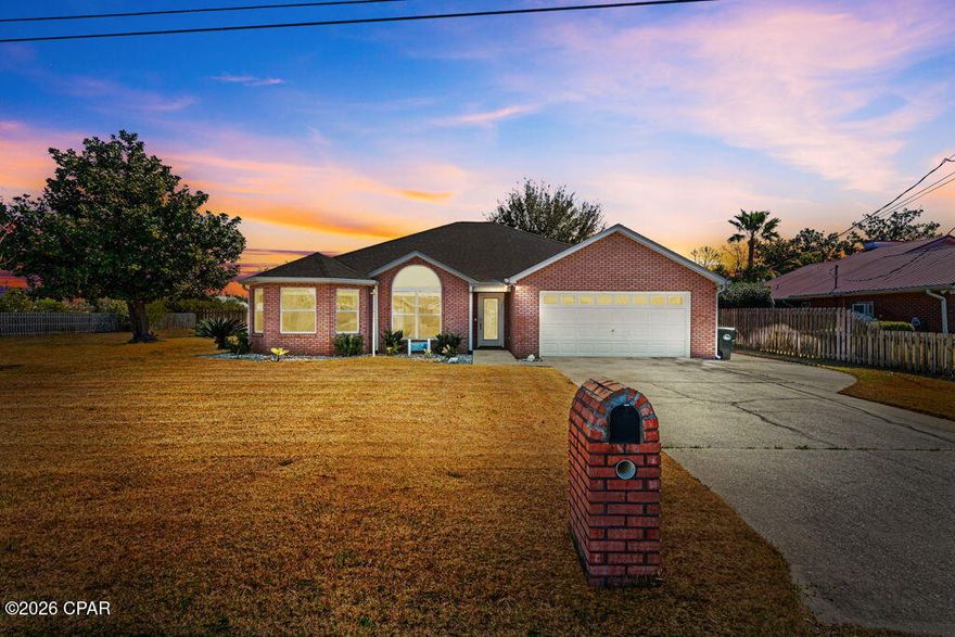 Beautifully updated and move-in ready, this 3-bedroom, 2-bath split floor plan home offers space, privacy, and thoughtful upgrades throughout. Situated on approximately 0.34 acres, the property is aligned next to a neighborhood easement providing additional open space and privacy. The home underwent a major renovation in 2020 with numerous upgrades, including RevWood flooring, updated kitchen cabinetry and bathroom vanities, windows, HVAC system, roof, spray foam insulation, gutters, doors, trim, baseboards, lighting fixtures, switches, outlets, and interior paint. A Generac whole-house generator adds peace of mind during storms or power outages. 

Inside, the living and dining areas feature cathedral ceilings with beautiful cedar beams, while crown molding throughout adds an elegant finishing touch. The living room fireplace has been updated with electric fire logs for easy enjoyment. The spacious primary suite features a distinctive cedar box beam ceiling and an ensuite bath with a large walk-in shower with dual shower heads, bench seating, and a marble vanity top.

The fully fenced backyard offers plenty of room for outdoor living and includes raised garden beds perfect for flowers, herbs, or homegrown vegetables. The adjacent easement creates a unique sense of openness rarely found in neighborhood settings.
Conveniently located near schools, shopping, and just a short distance from North Bay, this home combines modern updates with comfortable living in one of Lynn Haven's most desirable areas.
All measurements approximate; buyer to verify if important.