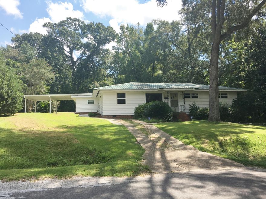 4BR/2.5 Bath home joining State Greenways and Trails public area offering nature and quietness. This home has both Formal Living room and formal dining room, split bedroom plan and a large family room with fireplace and all with double pane windows. The yard is partially fenced, has a work shop, boat shed and has scuppernong vines and Satsuma Tree that are loaded. Located close to shopping and downtown