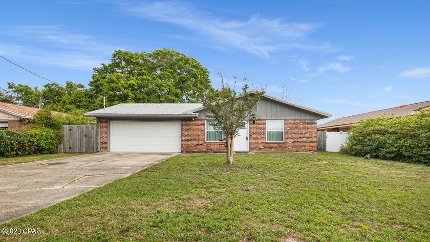 CURRENTLY UNDER CONTRACT, SELLER WILL CONSIDER BACKUP OFFERS. 3 bedroom/2 bath BRICK home centrally located just off of 23rd St. near restaurants, shopping, St. Andrews and more! To the right of the entryway sits a spacious living room with luxury vinyl plank flooring leading to the guest bathroom and bedrooms; To the left sits an open kitchen/dining area featuring tile flooring, stainless steel appliances and pantry. Just off the kitchen is the laundry room and garage. This home has been very well maintained featuring a metal roof, 6 ft privacy fence. New updates including; upgraded shower fixtures, new sewer line 2019, windows 2019, oven 2019, vinyl floors 2020, carpet 2021, attic insulation 2022, dishwasher 2022. This home is move-in ready, call to schedule your private showing today!