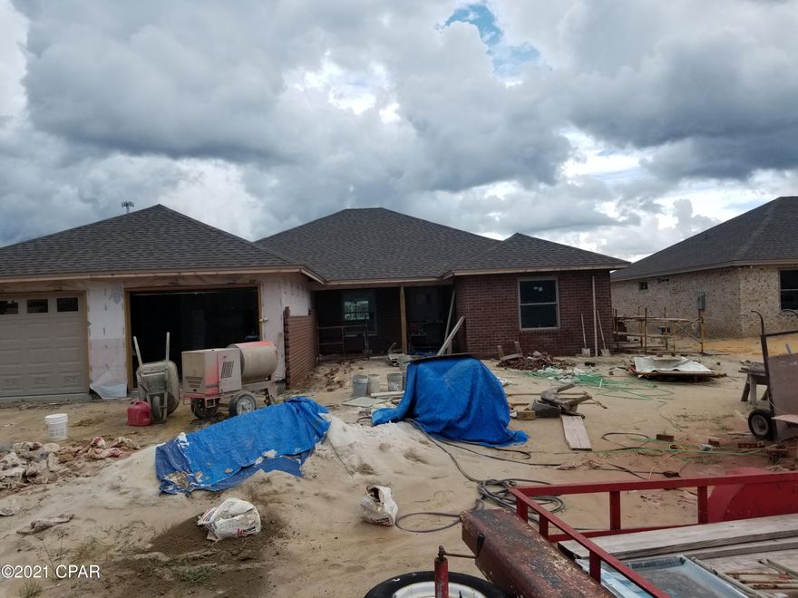 Under construction, luxury 4 bedroom 2 bath all brick home that offers large open floor plan, Master bath with his & hers double shower with Rain maker (3 shower heads) and shower seat, double vanity, large master bedroom with built-in rope lighting and large walk-in closets. The kitchen is a dream with all real hard white wood cabinets, granite countertops, stainless steel appliances, cabinets in the laundry room. Living room with high tray ceilings with rope lighting, electric fire place, crown molding and wired for entertainment. Home comes with large Florida room, front porch, and open back porch, security system, thermoseal spry foam system and generator ready electrical outlet with cord. outside shower and sprinkler system. Hurricane built See pictures. Lock in price before it go up again. We use Simpson Tie down and corner tie down straps and brackets, walls bolted to foundation as well as 2+6s. DP 50 windows, hip roofing just a few we do for a strong hurricane strength house. See pictures with out dry wall. About 90 days out from completion.