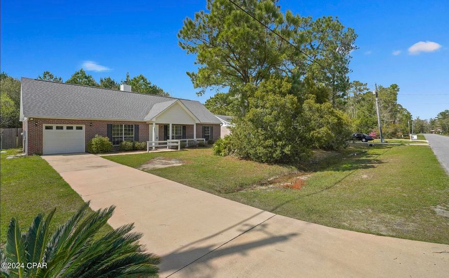 MOVE IN READY and boasting the luxuries of space, privacy and convenience, this lovely 3 bedroom 2 bathroom ranch style home sits on .33 of an acre, South of Hwy 20, and just 15 minutes from the beautiful beaches of South Walton. A charming front porch welcomes you to an open living area with vaulted ceilings and a fireplace.Just beyond the living area is a separate dining area, adjacent to the spacious galley style kitchen.Beyond the kitchen is a bonus room with an enclosed laundry area as well as a door providing interior access to the oversized onecar garage.There is a large fenced back yard, (with an orange tree!), and plenty of room for a pool, summer kitchen and much more!  Some recent updates and improvements include: the entire interior of the home was painted in 2024, the roof was replaced late 2018, a new HVAC installed in 2019, backyard fence installed in 2017.  Don't miss out on this one! Schedule your showing today!