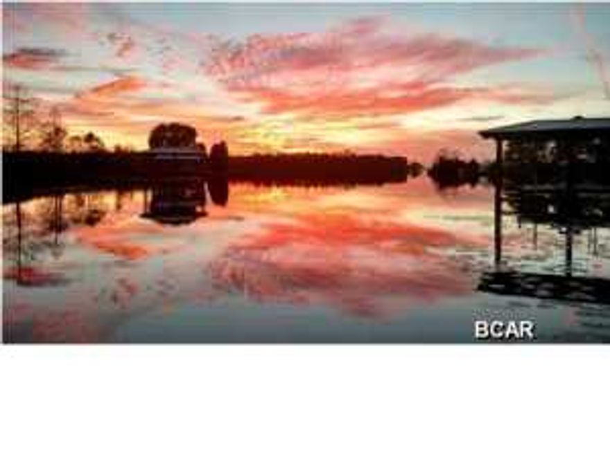 PRICE REDUCED SIGNIFICANTLY-01-13-2015-----Make your appointment to see or to revisit---Looking for waterfront house with panoramic lake views from every window & and a dock with hydraulic boat lift? Would you like to have a secluded place that is on 1.35 acres of beautiful wooded and lushly landscaped private land? Have you always wanted a house with enough land to build a beautiful pool in a lake front setting? Is convenience to the new airport, downtown Panama City, and the mall important to you? Do you want your children to attend highly rated schools in close proximity to home? Do you appreciate quality craftsmanship with impeccable details such as step down crown molding, french doors, highly detailed brick fireplace, stainless appliances, split bedroom floor plan, hardwood and