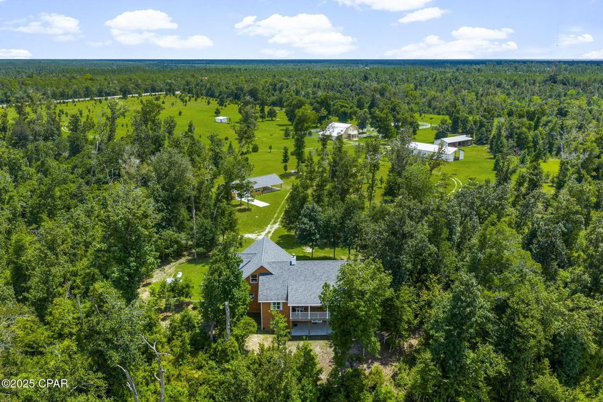 100-Acre Equestrian Estate with Creek, Luxury Home, Barn, & Barndominium.
Exceptional 100-acre estate with creek frontage, luxury residence, and equestrian facilities - offered as three total parcels. Immaculately maintained grounds feature rolling pastures, rare trees, and a scenic creek winding through the property. 

Parcel 1 - 35 Acres
The main residence is a showcase of state-of-the-art construction with 2,962 heated/cooled sq ft, offering 5 bedrooms, 3 full bathrooms, and a gourmet kitchen with cherry soft-close cabinets, granite, stainless appliances and a large gathering island. The 30' wide balcony captures breathtaking views of the surrounding landscape, while the owner's suite features a spa-like ensuite bathroom with a soaking tub, walk-in shower, and dual walk-in closets. The main level is a split bedroom floor plan with engineered hardwood flooring throughout the main living areas and bedrooms. The two additional bedrooms, and full bathroom with double vanities are on the opposite side of the home from the owner's suite.
The second floor offers two bedrooms and a full bathroom, ideal for guests or family, while the main level ensures room to spread out.
A 60' unfinished basement on a solid concrete slab provides endless possibilities, complete with a covered porch and windows. Every detail has been thoughtfully designed, including a fire suppression system, central vacuum, Generac whole-house generator with auto start, and Culligan water filtration system. A spacious three-car garage completes this home. 

An immaculate workshop provides versatility with a two-car garage, farm style sink, refrigerator, and a full bathroom - perfect for a hobby room, separate office/home business, or additional storage.

Parcel 2 - Adjoins parcel 1 to the north with approximately 30 Acres of heavily wooded grounds, and approximately 975 ft of creek frontage, perfect for trails, hunting, or privacy. 

Parcel 3 - 35 Acres
The southernmost parcel serves as the equestrian and agricultural heart of the property. Here you'll find the barndominium, equestrian barn, fenced pastures, and multiple equipment storage buildings. The barndominium offers approximately 1,444 sq ft of living space, with a full kitchen, half bath on the main level, and an upstairs master suite with a balcony featuring a spa-style bathroom, double vanities, dual walk-in closets, a spacious living room, and bonus/flex space.
Equestrians will delight in the barn facilities, which include three horse stalls with pivot feeders, a wash station, and an automatic fly-spray system in the stalls. The barn also has an oversized laundry facility, feed room, and back-up generator. The pastures are fully fenced with a run-in shed, raised covered feeding area, and two additional storage buildings for equipment behind the barn. 
Beyond its exceptional amenities, the estate is enhanced with over 2,000 trees thoughtfully planted across the landscape, creating a one-of-a-kind natural sanctuary. A gated main entry and two additional gated access points ensures both privacy and convenience for the three different parcels offered. 

A rare opportunity to own a luxury creekfront equestrian estate designed for both comfort and functionality.

*All measurements and information approximate, please verify if important.