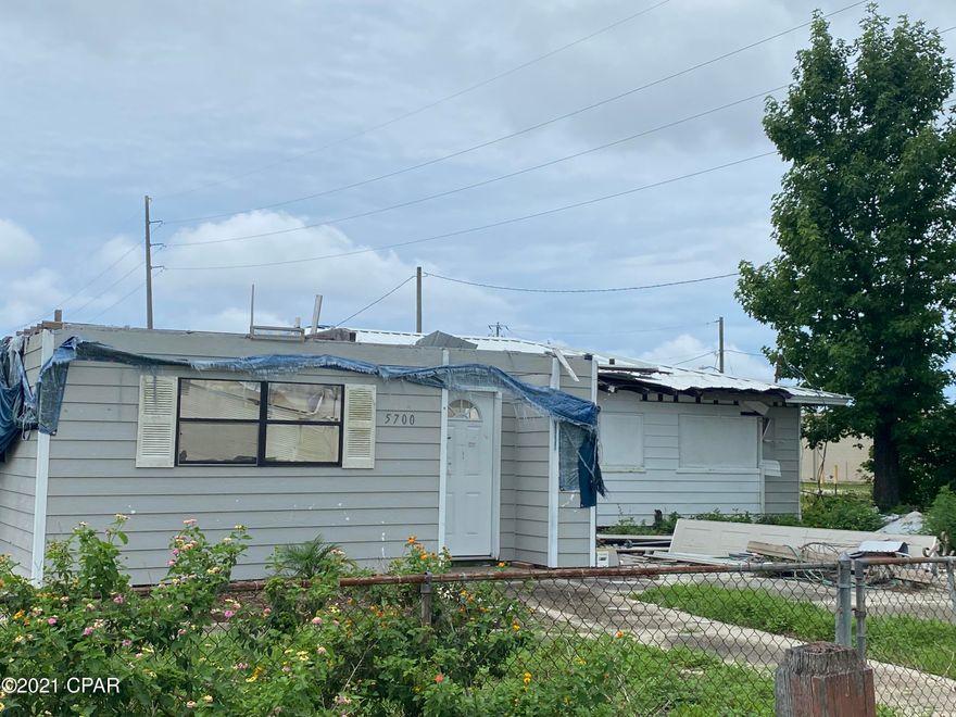 Storm Damaged Home, value is in the Lot. Located off Tyndall Parkway. Theres county water and sewer on the lot. Seller will not remove the house.  Please verify all information.